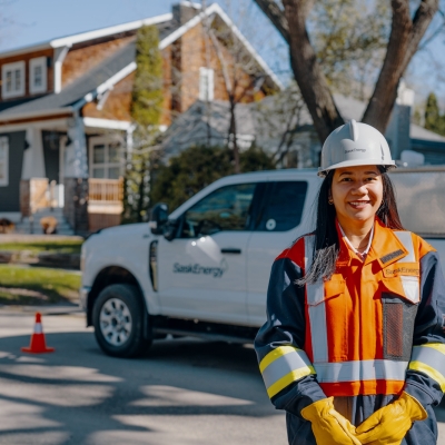 Service Technician SaskEnergy worker poses in front of SaskEnergy truck